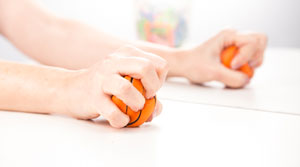 Pair of hands squeezing stress balls